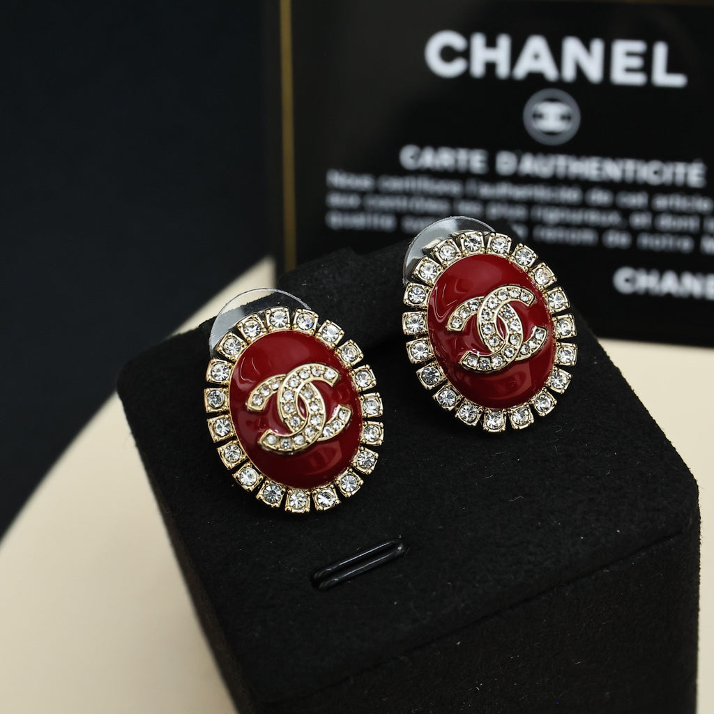 Silver-tone round logo stud earrings with red enamel and clear crystals