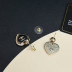 Mixed heart earrings: black CC heart with stud and silver textured heart on gold posts
