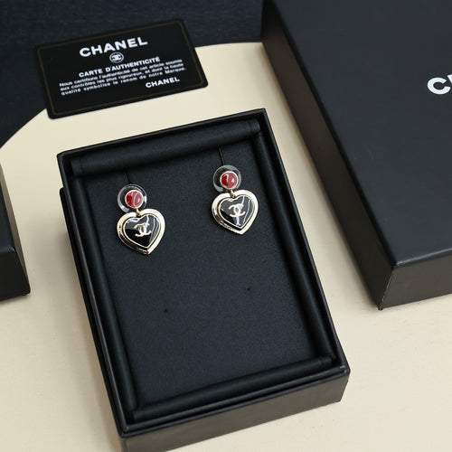 Pair of heart dangle earrings with red enamel tops, gold-tone CC logo, and black hearts