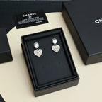 Heart drop earrings set with silver-tone posts in a black display box