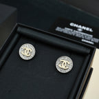 CC stud earrings, round silver-tone with pavé border and gold CC center, in box