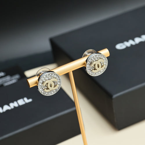 CC stud earrings, round pavé border silver-tone with gold CC center on stand