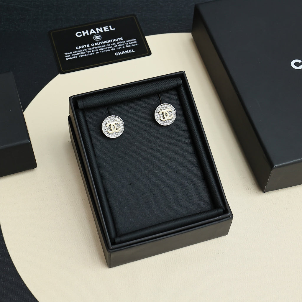 CC stud earrings set in black display box, round silver-tone pavé