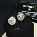 CC stud earrings, round silver-tone with pavé border and gold CC center