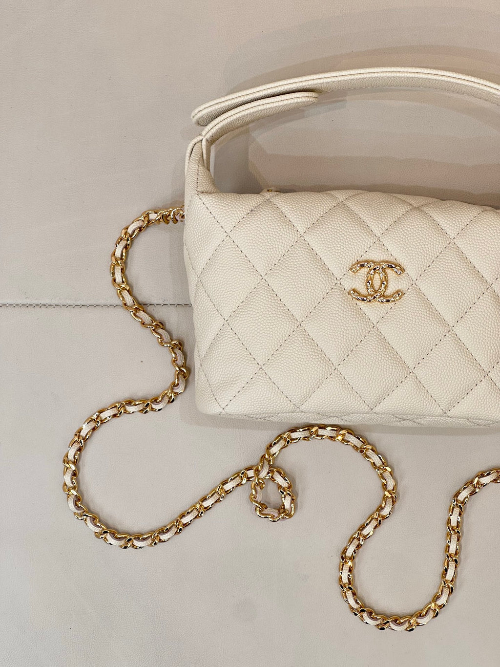 Chanel quilted mini bag, white, with gold chain strap and Chanel logo detail