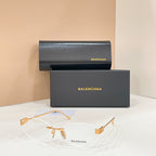 Sunglasses with clear lenses and gold-tone frames