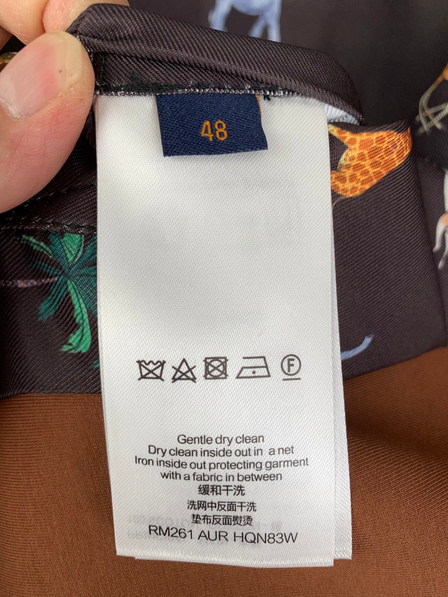 Care label for long-sleeve jacket: gentle dry clean, iron inside out