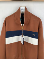 Brown zip-up jacket with stand collar, blue and white stripes, gold zipper pull
