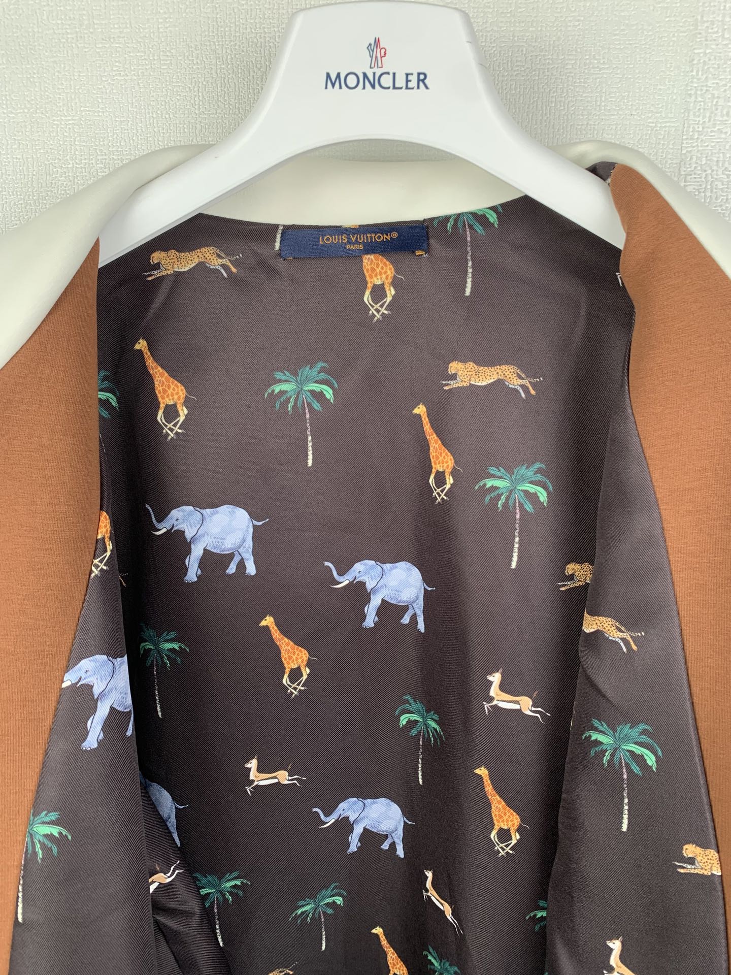 Long-sleeve jacket lining with Louis Vuitton label; dark animal-print pattern