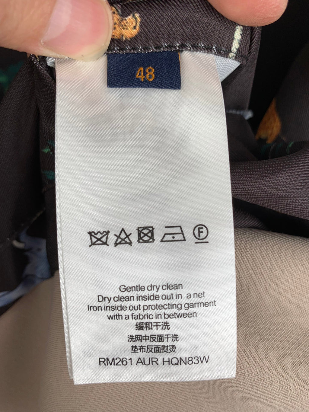 Care label on Louis Vuitton patterned long outerwear, size 48