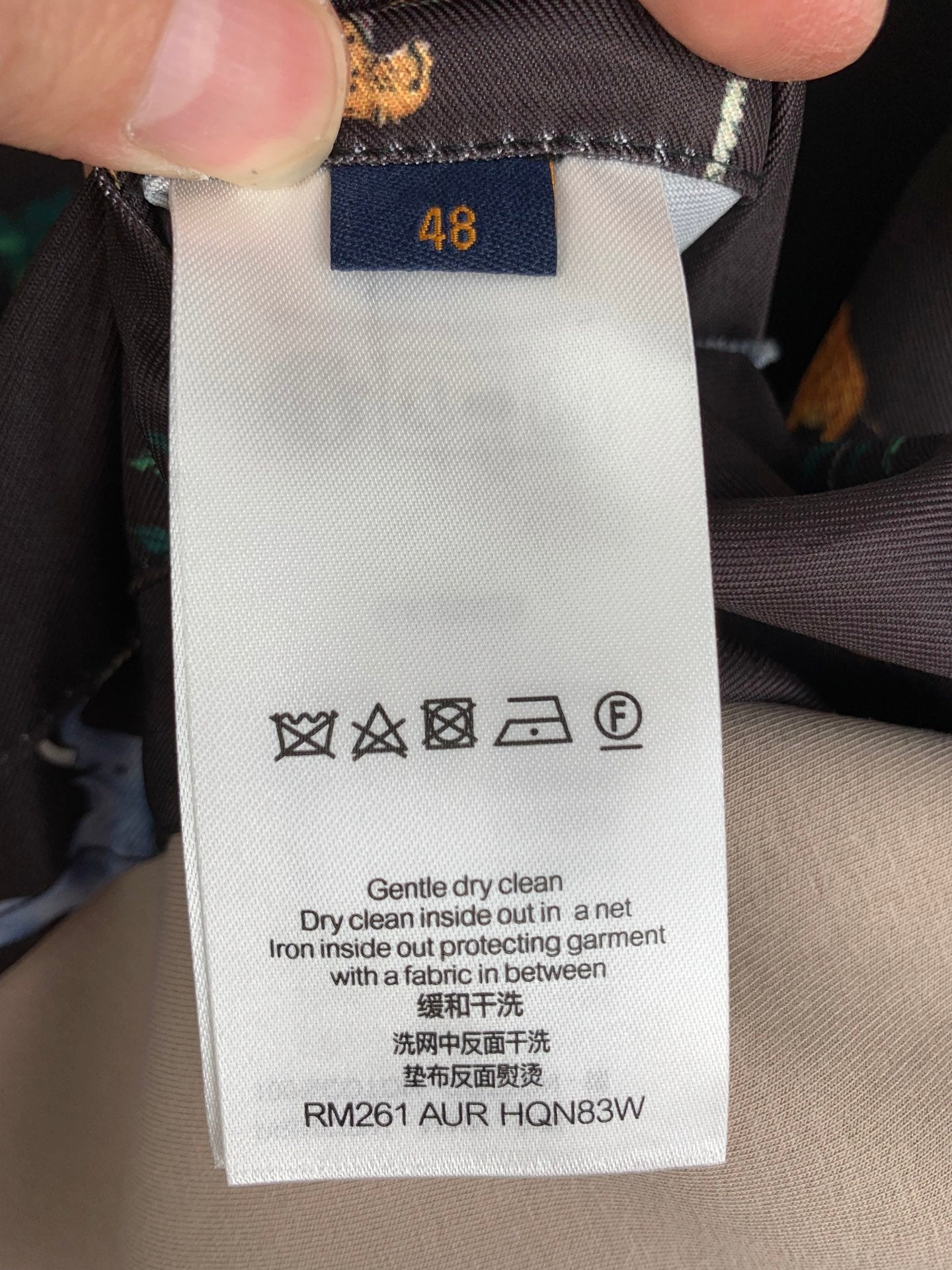 Care label on Louis Vuitton patterned long outerwear, size 48