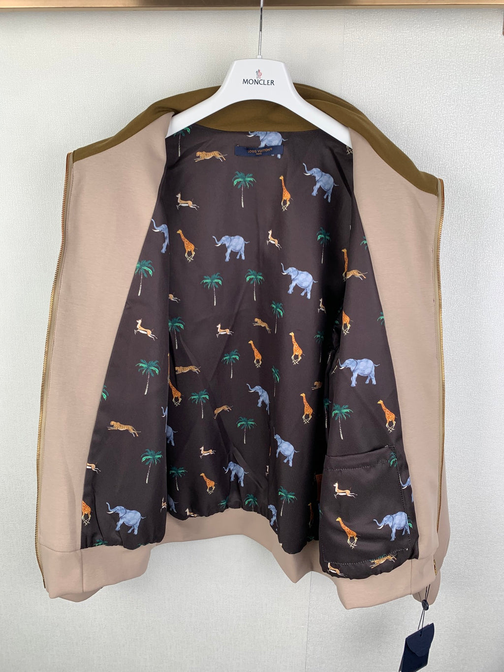 Long Louis Vuitton outerwear with tan sleeves and dark animal-print interior