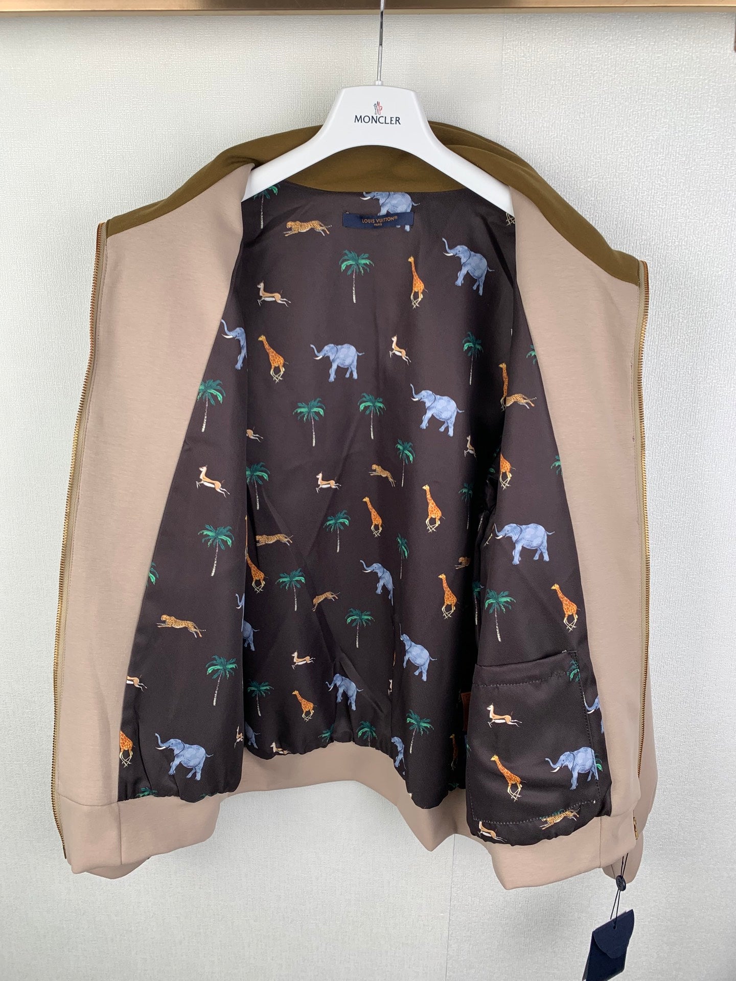 Long Louis Vuitton outerwear with tan sleeves and dark animal-print interior