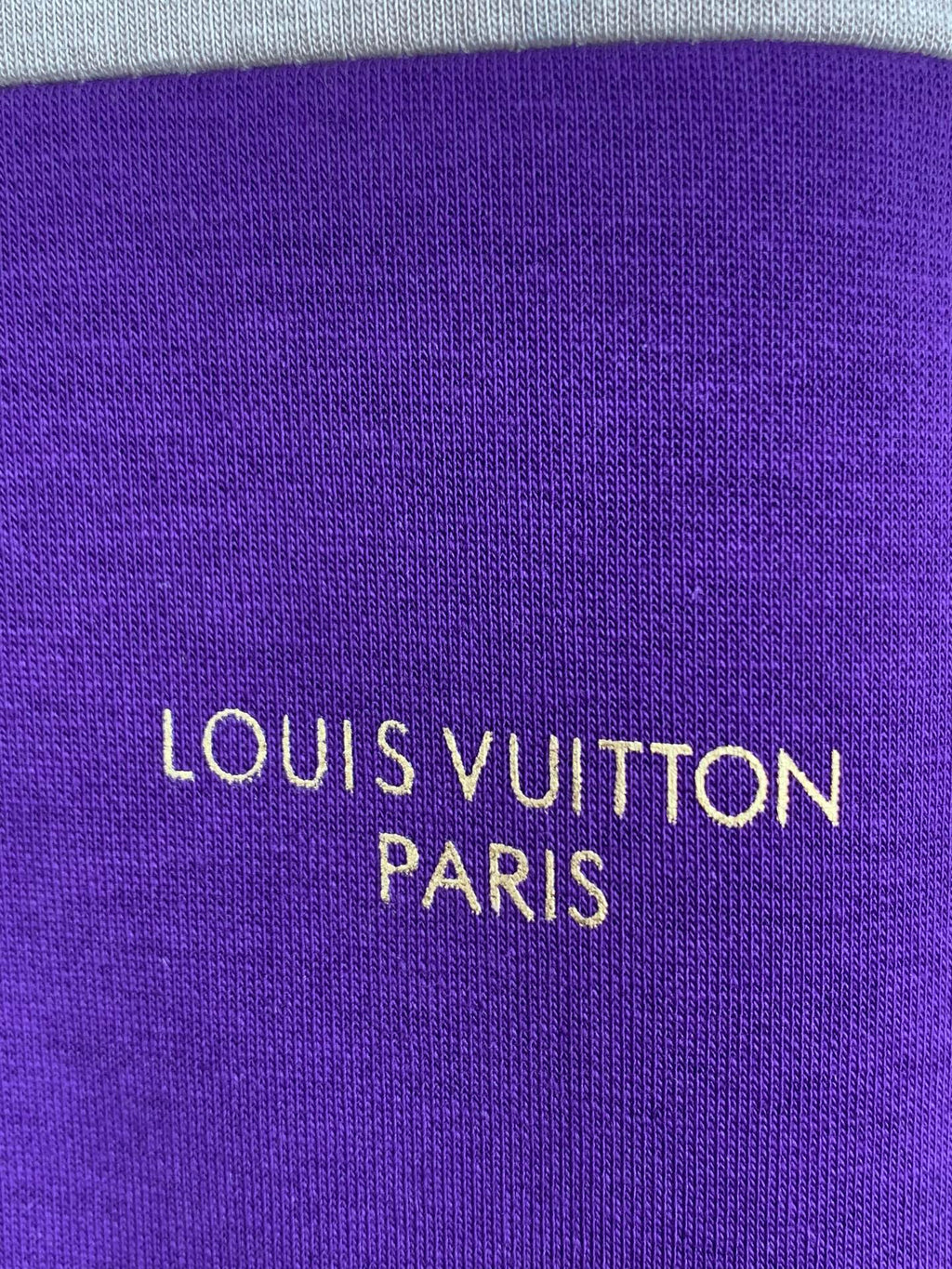 Purple knit fabric panel with “LOUIS VUITTON PARIS” logo text