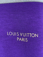 Purple knit fabric panel with “LOUIS VUITTON PARIS” logo text