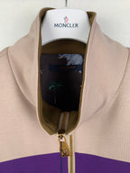 Beige jacket with purple and olive stripe, gold zipper pull and interior lining detail