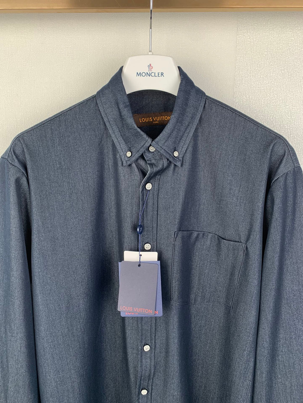 Dark blue button-up shirt with spread collar and chest pocket, front view