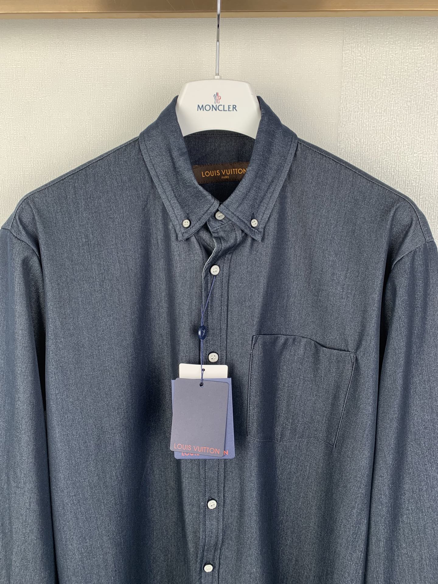 Dark blue button-up shirt with spread collar and chest pocket, front view