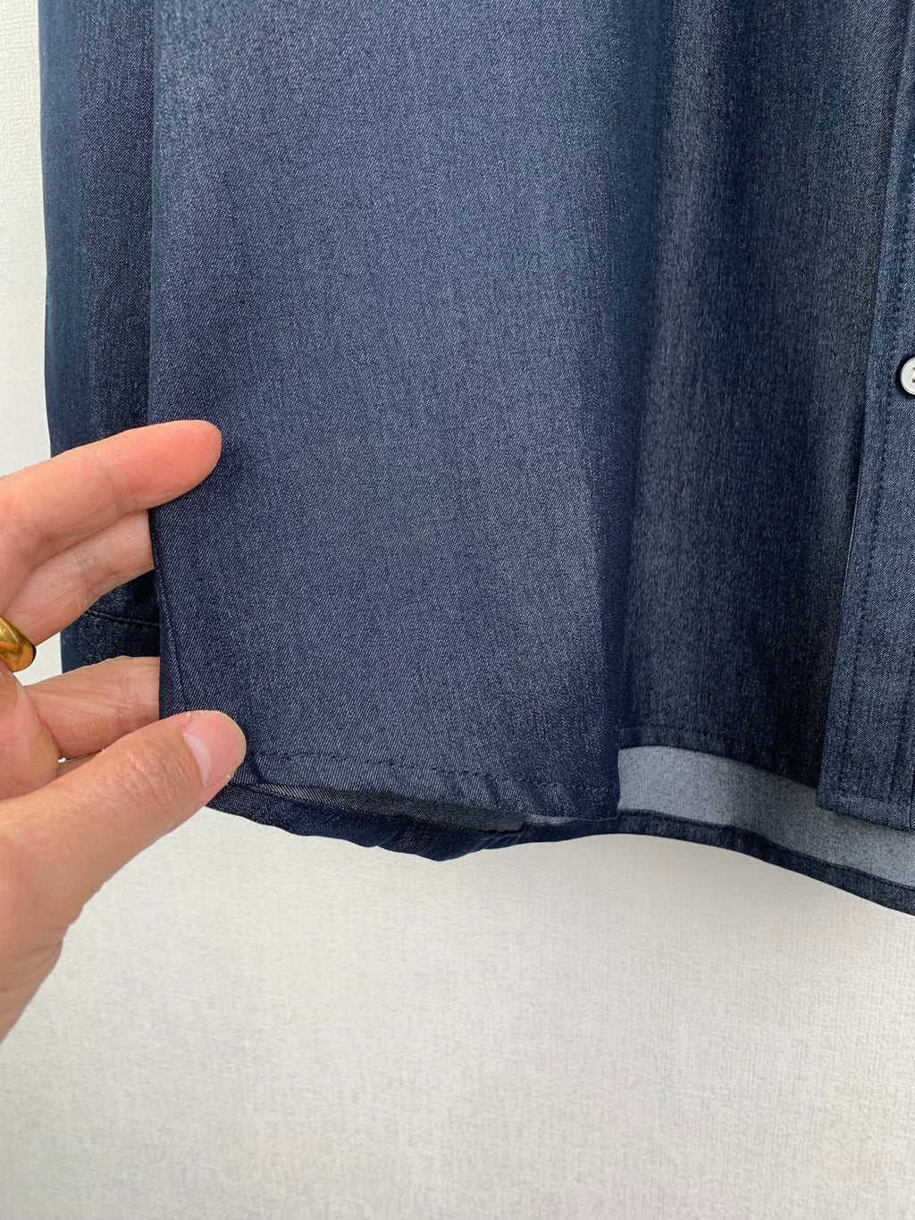 Dark blue shirt hem and inner underlayer in shadowed light