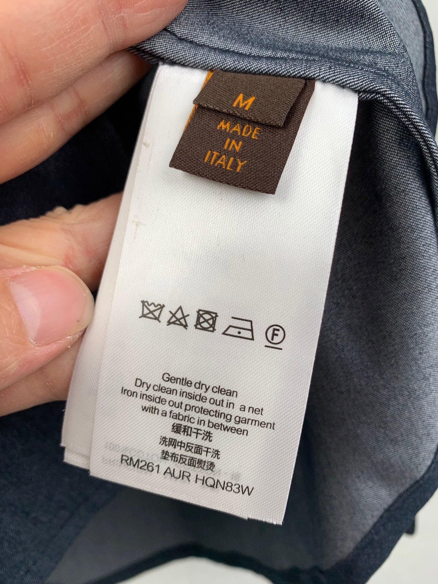 Dark denim garment interior with clothing care label and size code