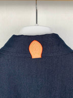 Dark blue shirt back with orange patch detail at upper yoke