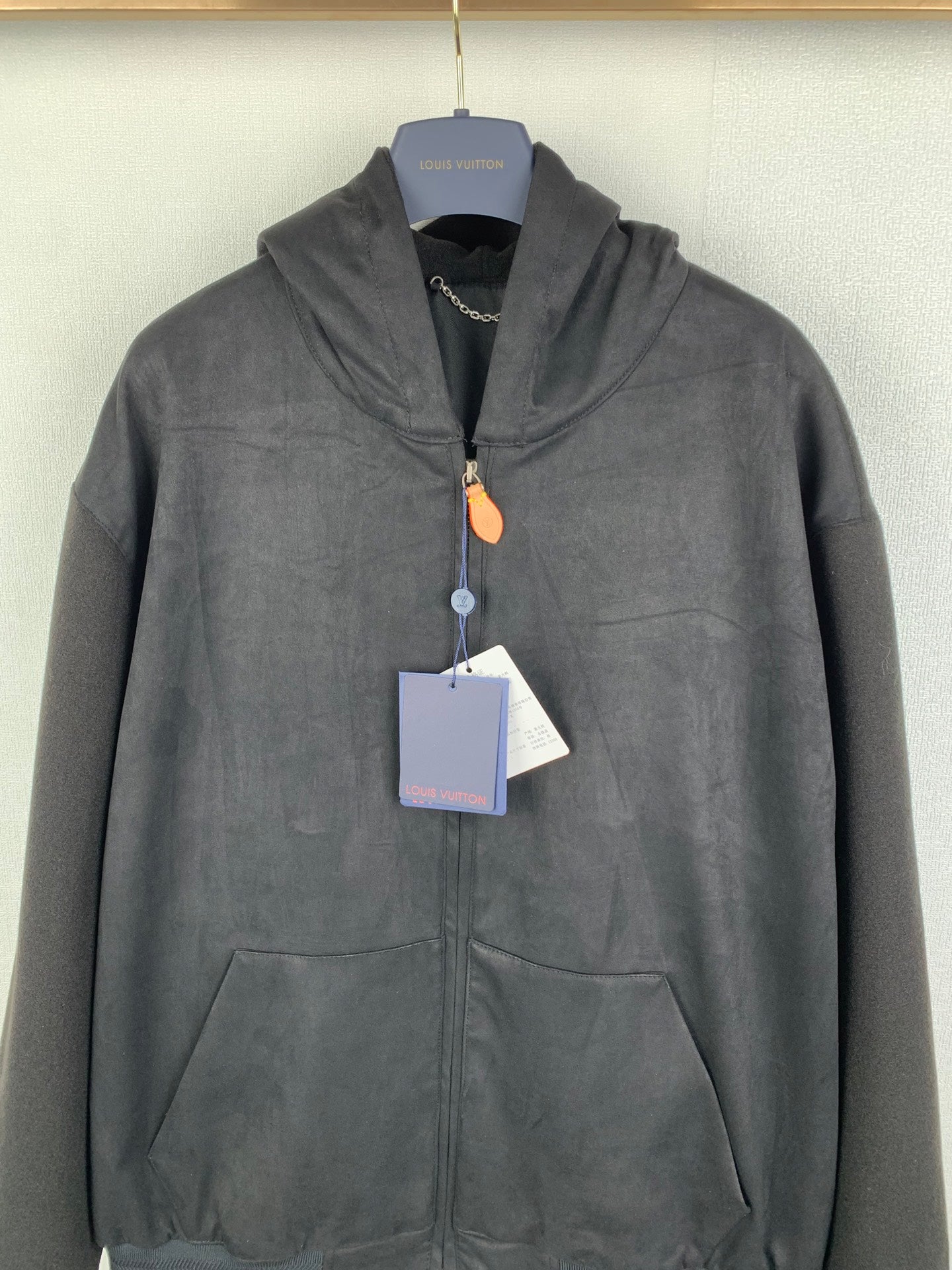 Louis Vuitton hooded zip-up jacket, dark gray, front view with hood and pockets