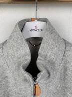 Grey zip-up jacket with stand collar and front zipper, fabric close-up