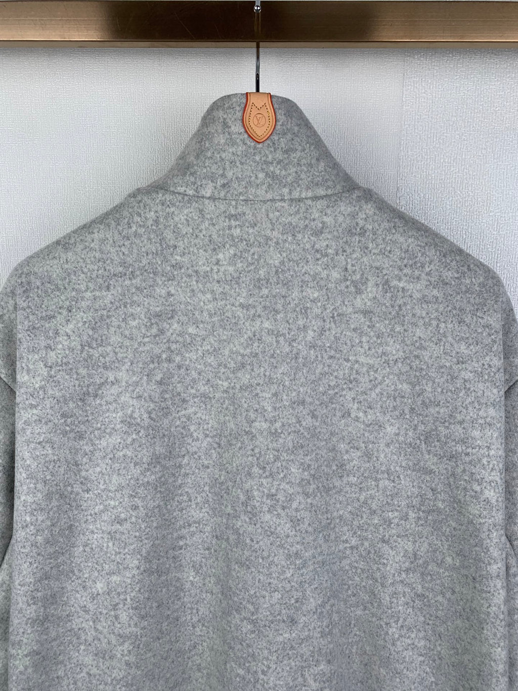 Grey zip-up jacket with stand collar, back view detail