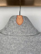 Grey zip-up jacket collar detail with tan leather patch