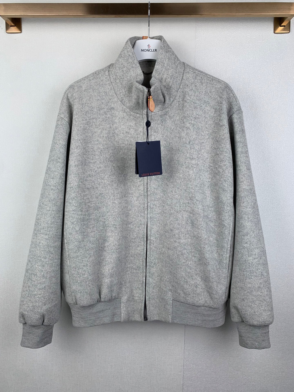 Grey zip-up jacket with stand collar, front zipper, and side pockets