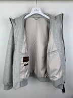 Grey zip-up jacket opened to show light inner lining and zippered pocket