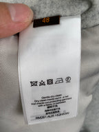 Long pants care label with size 48 and laundry icons