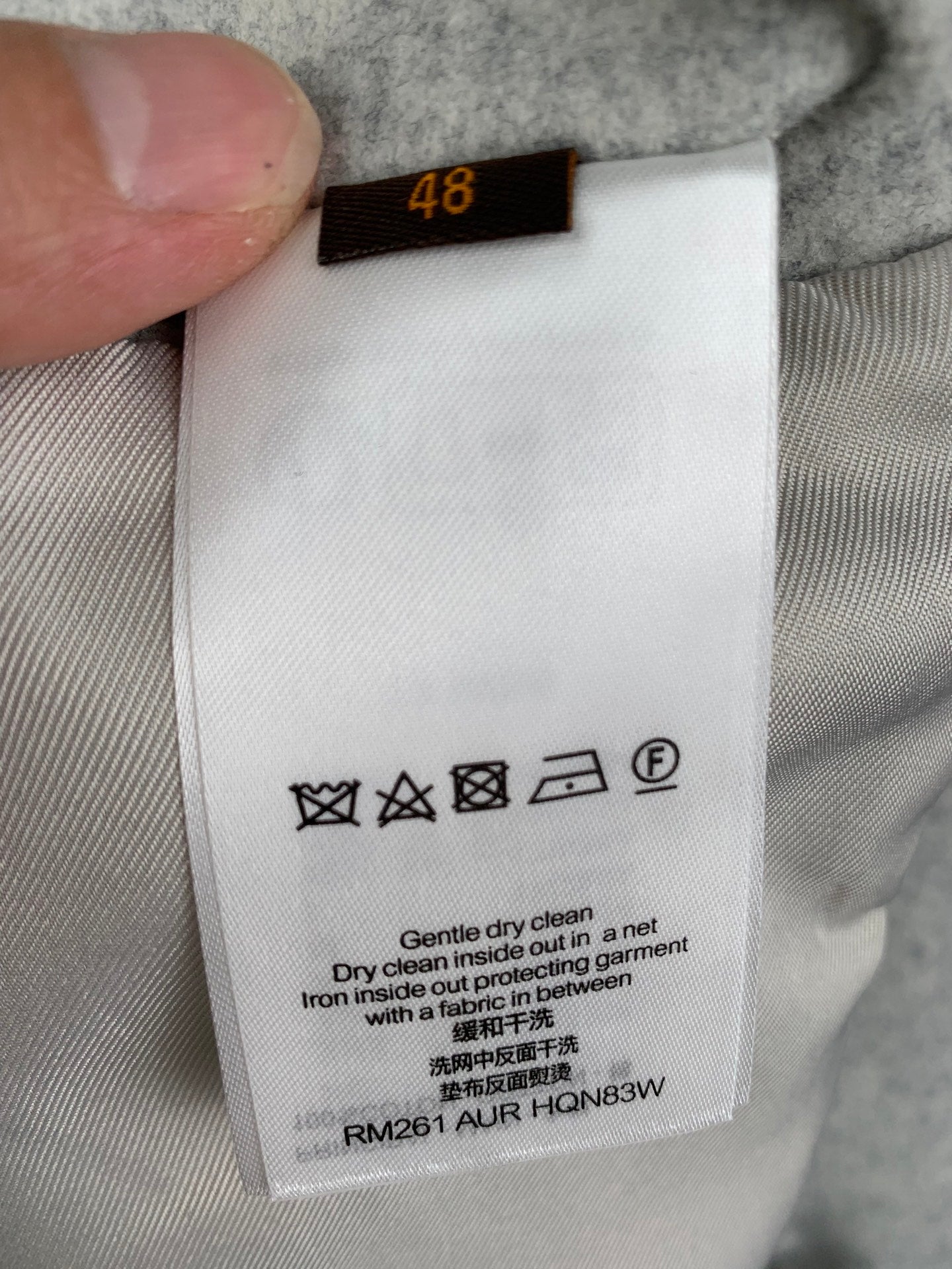 Long pants care label with size 48 and laundry icons