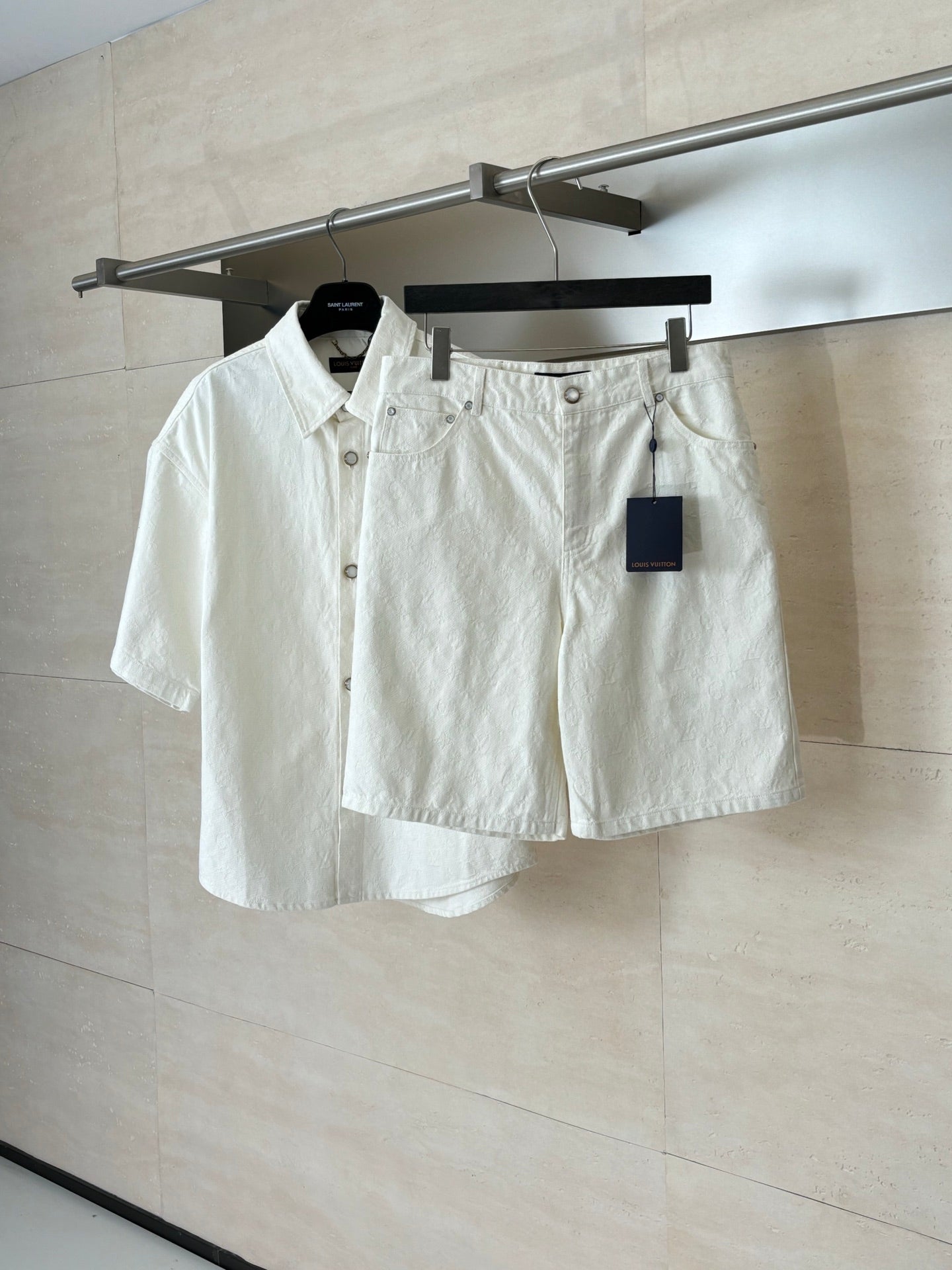 White denim shorts on hanger, button-front with belt loops and tag