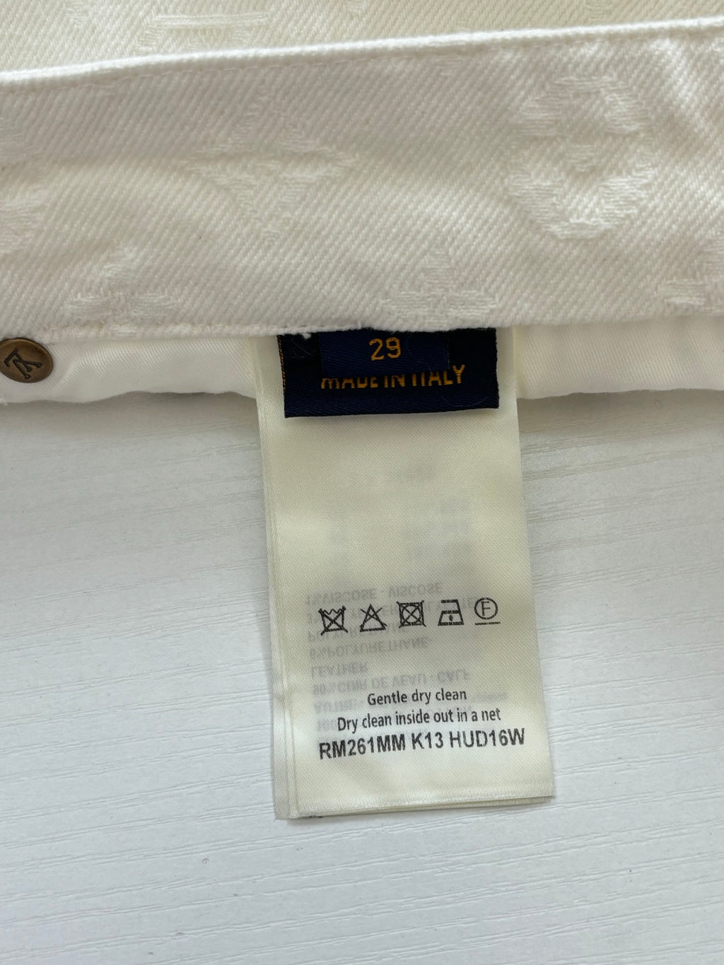 Beige pants inner care label with size 29 and washing symbols
