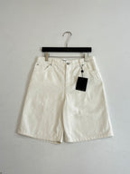 White denim shorts on hanger, button fly and two front pockets