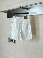 White denim shorts on hanger, front pockets and belt loops with hanging tag