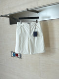 White denim shorts on hanger, elastic waistband and front button closure