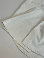 Louis Vuitton white short-sleeve shirt fabric close-up with subtle texture