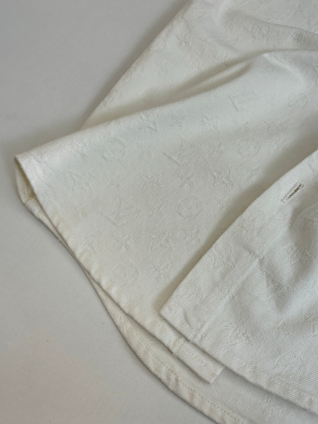 White button-up shirt fabric close-up with subtle textured pattern