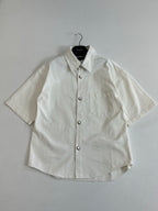 White short-sleeve button-up shirt laid flat, front view