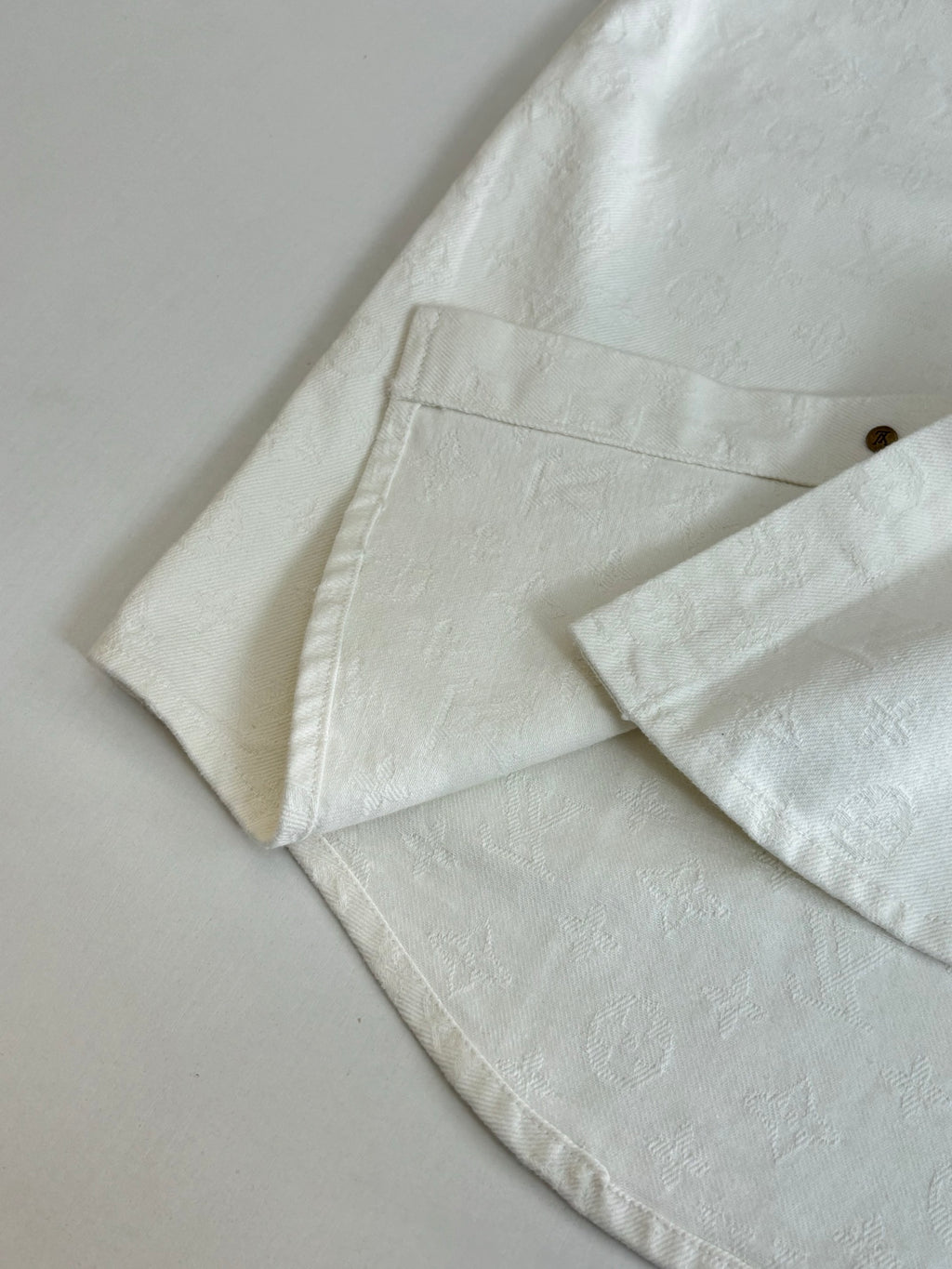 Louis Vuitton white shirt sleeve and hem detail with stitched seam