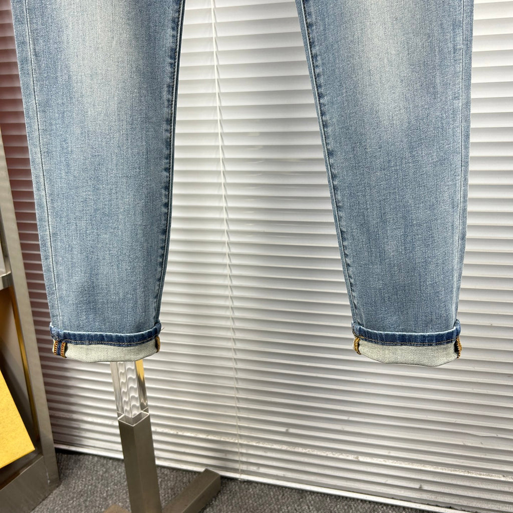 Light-blue denim jeans with cuffed hem and visible stitching detail