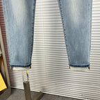 Light-blue denim jeans with cuffed hem and visible stitching detail