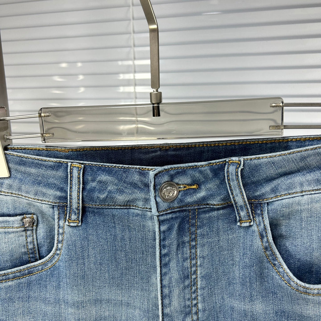 Denim jeans waist with logo button, belt loops, and front pocket stitching