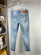 Light-blue denim jeans on hanger with embroidered back pocket details