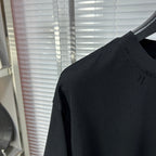 Black crew-neck T-shirt with short sleeves, textured knit and smooth shoulder seam