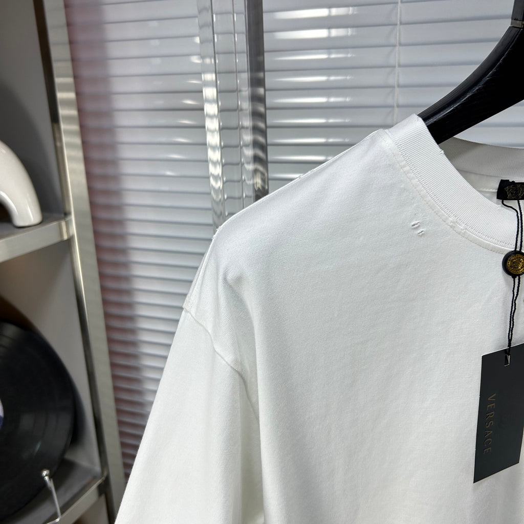 Versace white T-shirt sleeve and upper back with small stud marks