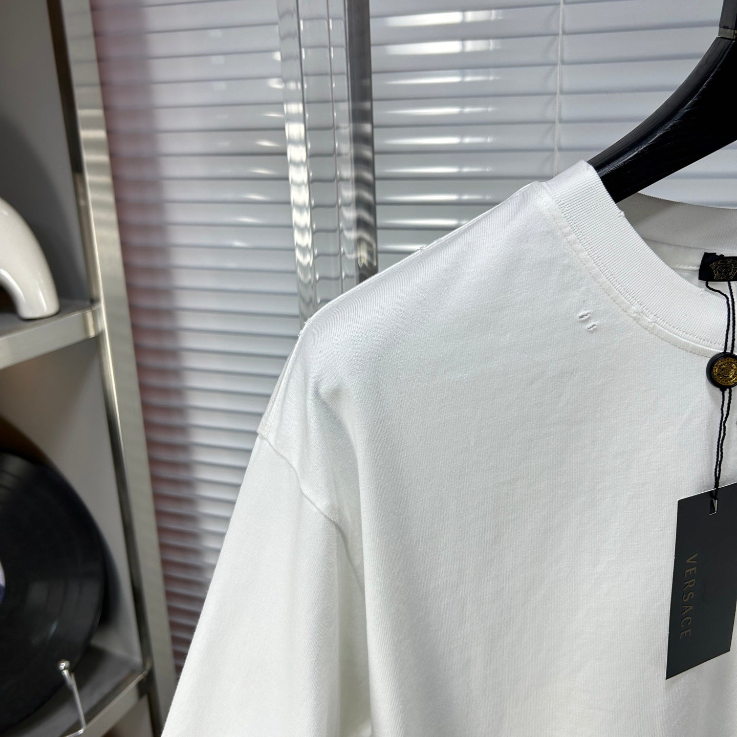 Versace white T-shirt sleeve and upper back with small stud marks
