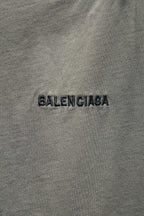 Balenciaga light gray T-shirt fabric close-up with BALENCIAGA logo text